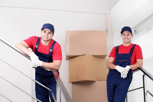 Mover wearing gloves and protective footwear during a house move