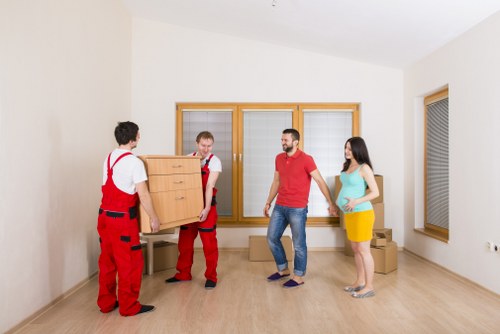 Movers handling furniture carefully with safe lifting practices